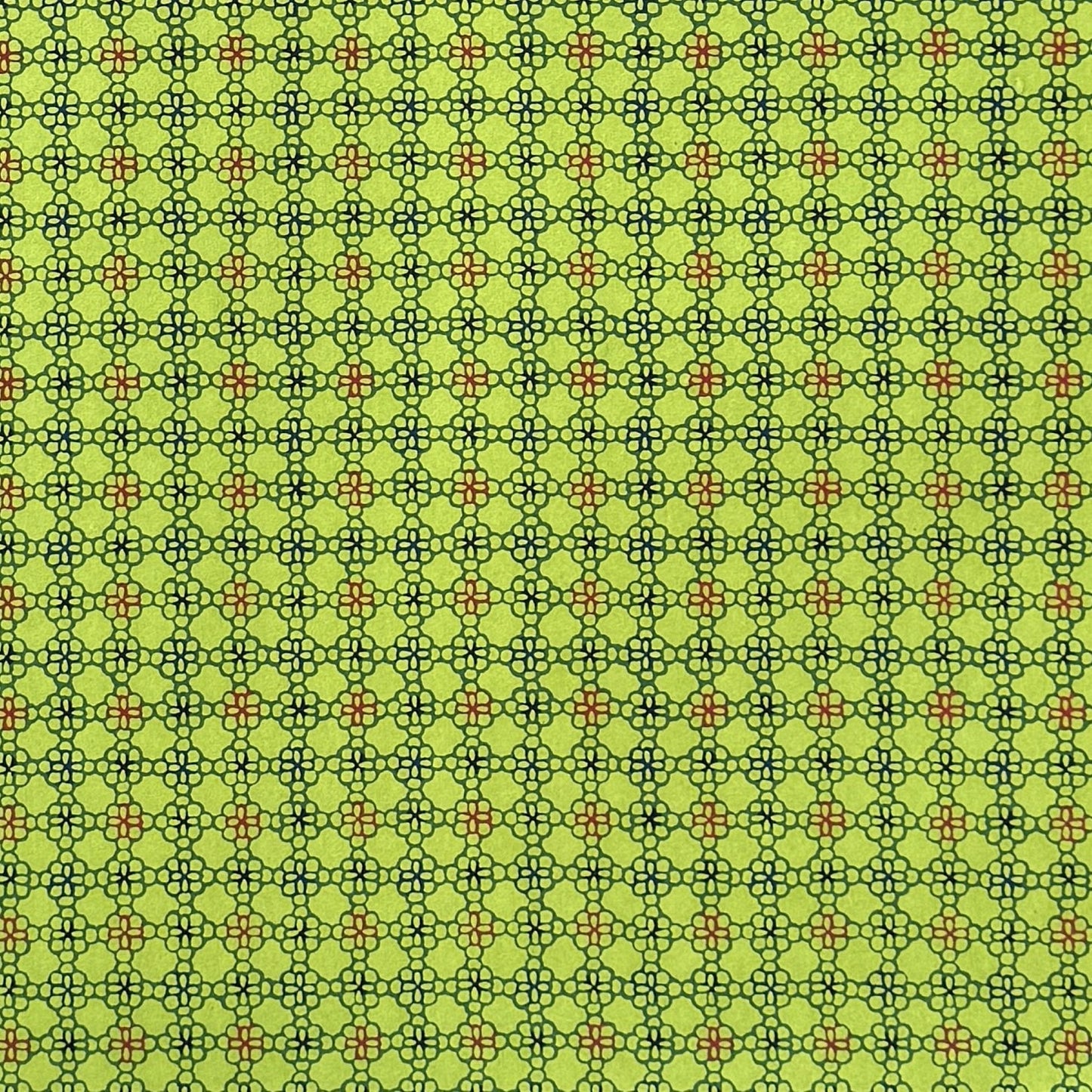 A sheet of Japanese katazome paper with a delicate floral tile repeat pattern on vibrant lime green