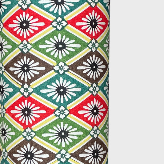 A sheet of katazome paper with a repeat rhombus pattern with the Japanese motif of the water caltrop plant (hishi) depicted alongside the four-petal flower of the water chestnut (hanabishi) in red, green. brown and teal.