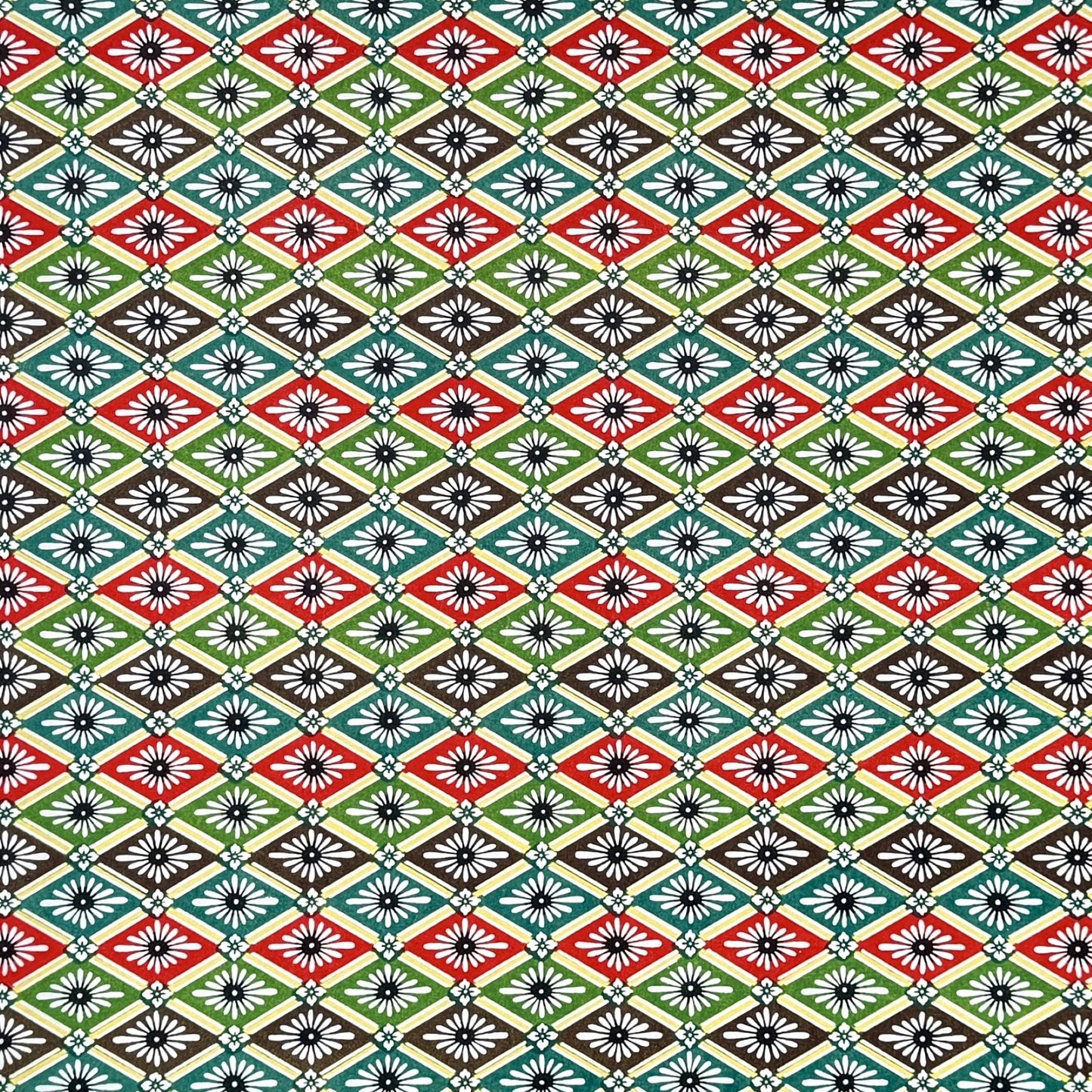 A sheet of katazome paper with a repeat rhombus pattern with the Japanese motif of the water caltrop plant (hishi) depicted alongside the four-petal flower of the water chestnut (hanabishi) in red, green. brown and teal.