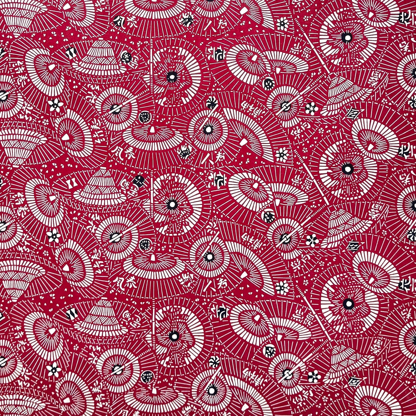 A repeat pattern of Japanese umbrellas (wagasa) in rich berry pink and white. A shhet of katazome paper
