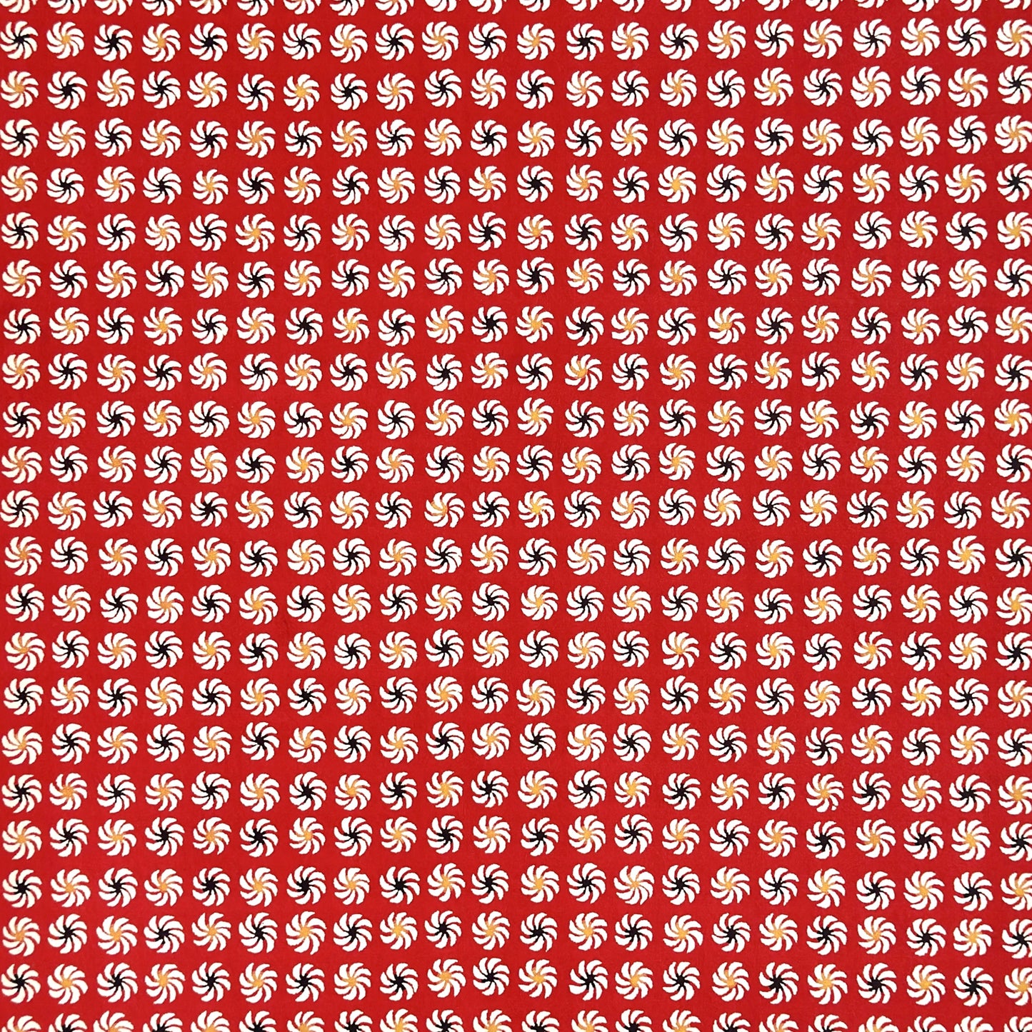 a sheet of Japanese katazome-shi paper with a repeat pattern of circular abstract flowers in white