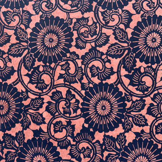 Japanese katazome-shi paper with a silkscreen of a chrysanthemum (kiko) flowers pattern in navy on blush pink