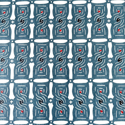 Japanese katazome stencil dyed paper with a repeat pattern of muted blue knots.