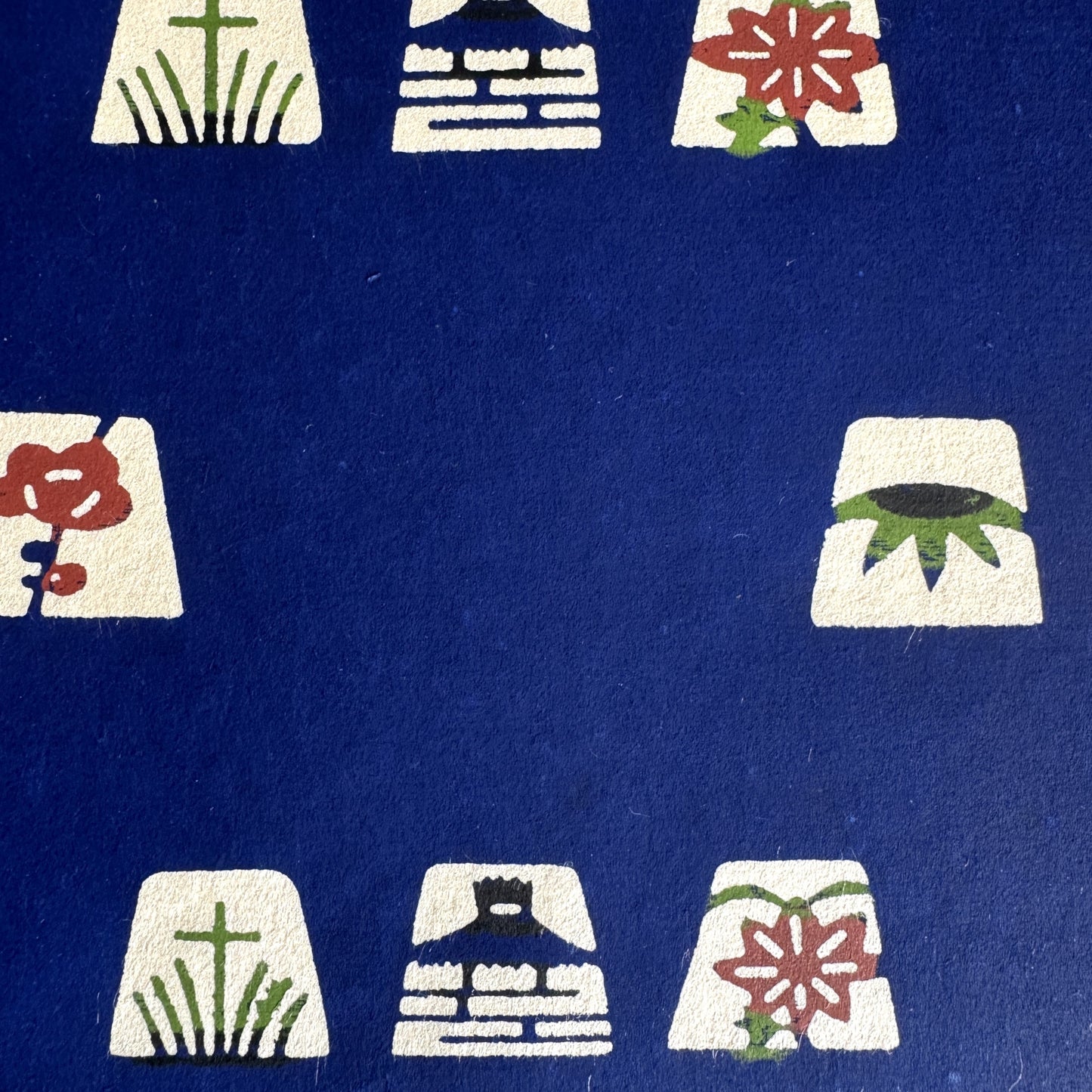 Japanese katazome-shi paper in blue with small Japanese Mon motifs. Close-up