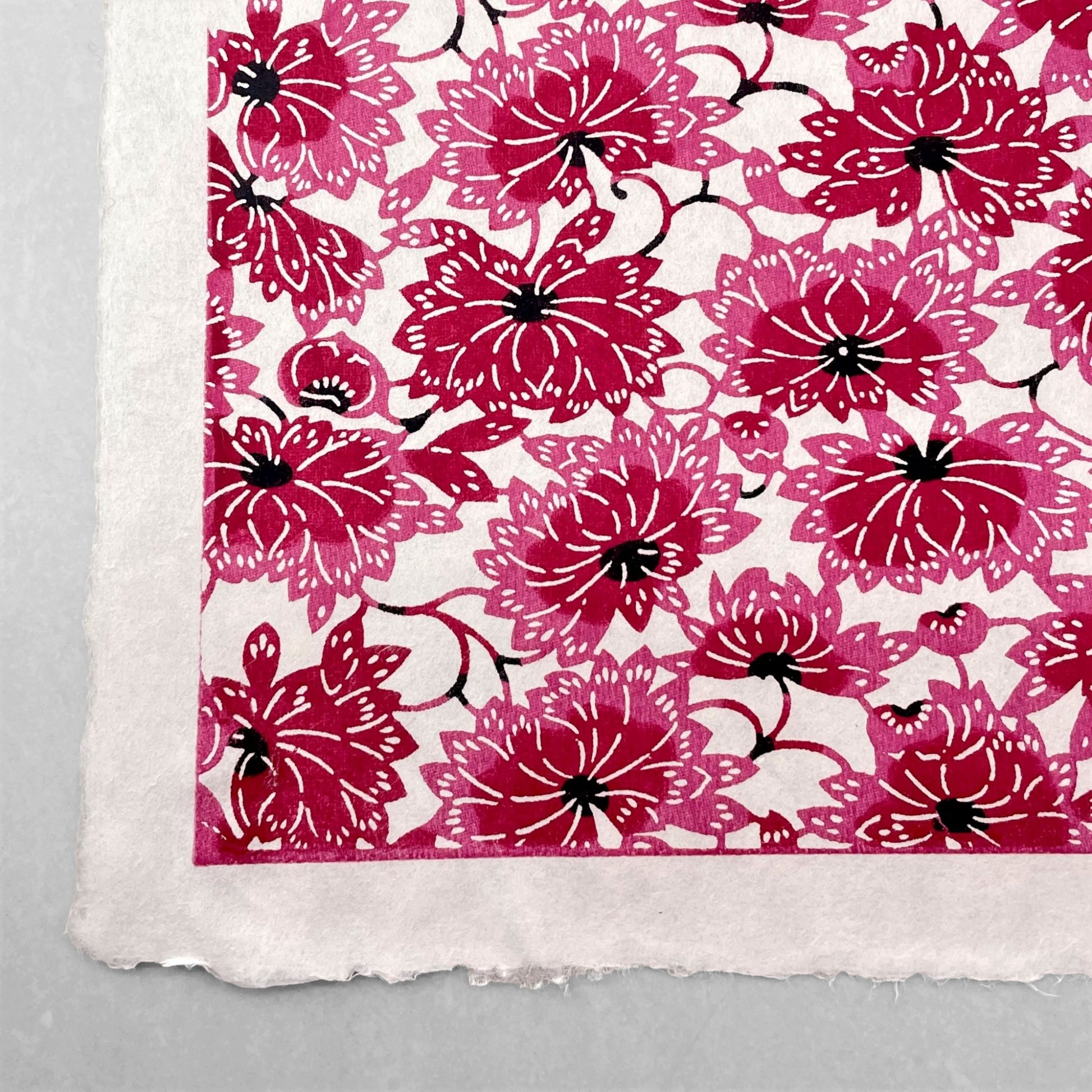 japanese stencil-dyed handmade paper with two-tone pink chrysanthemum repeat pattern