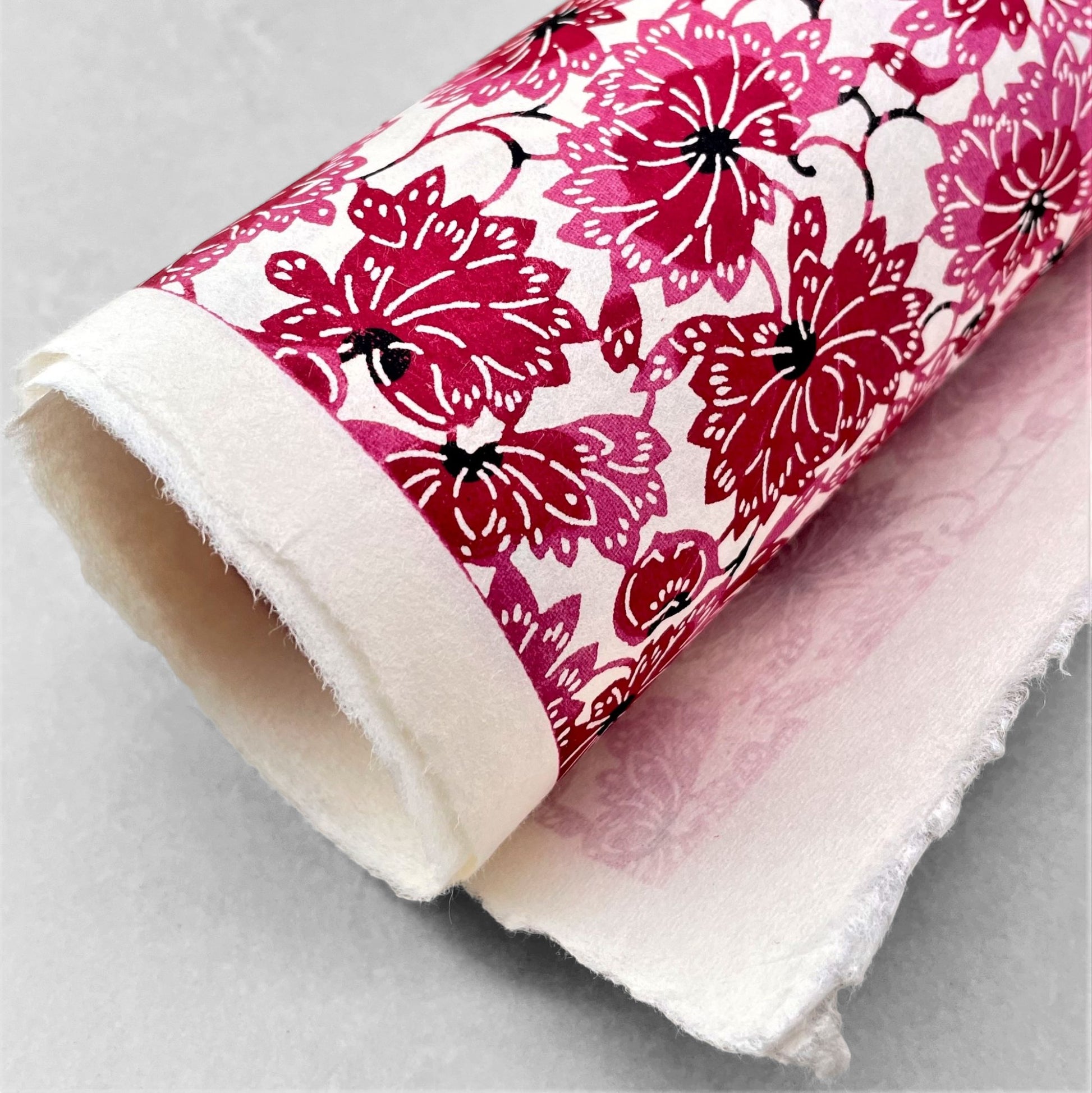 japanese stencil-dyed handmade paper with two-tone pink chrysanthemum repeat pattern