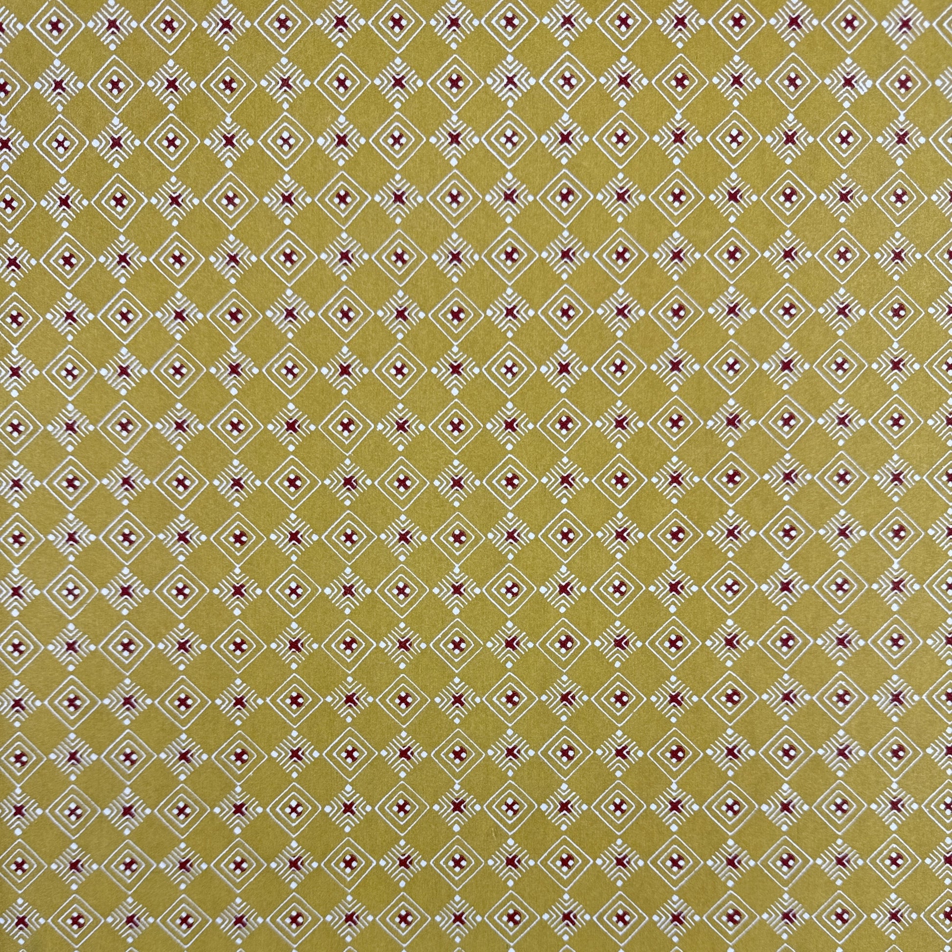 Japanese decorative stencil-dyed paper with repeat diamond pattern in a mustard gold colour.