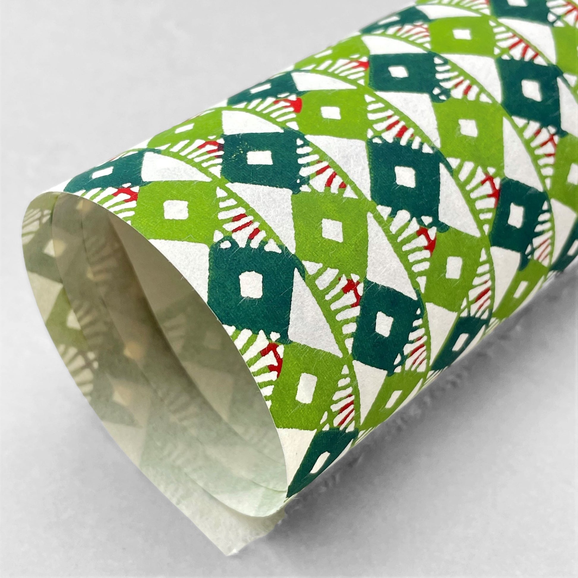 japanese stencil-dyed handmade paper with small scale diamond repeat pattern in two-tone green
