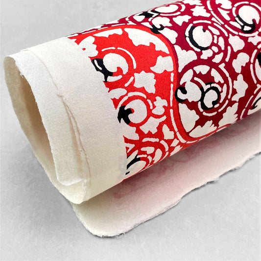 japanese stencil-dyed handmade paper with traditional arabesque vine pattern in red and maroon