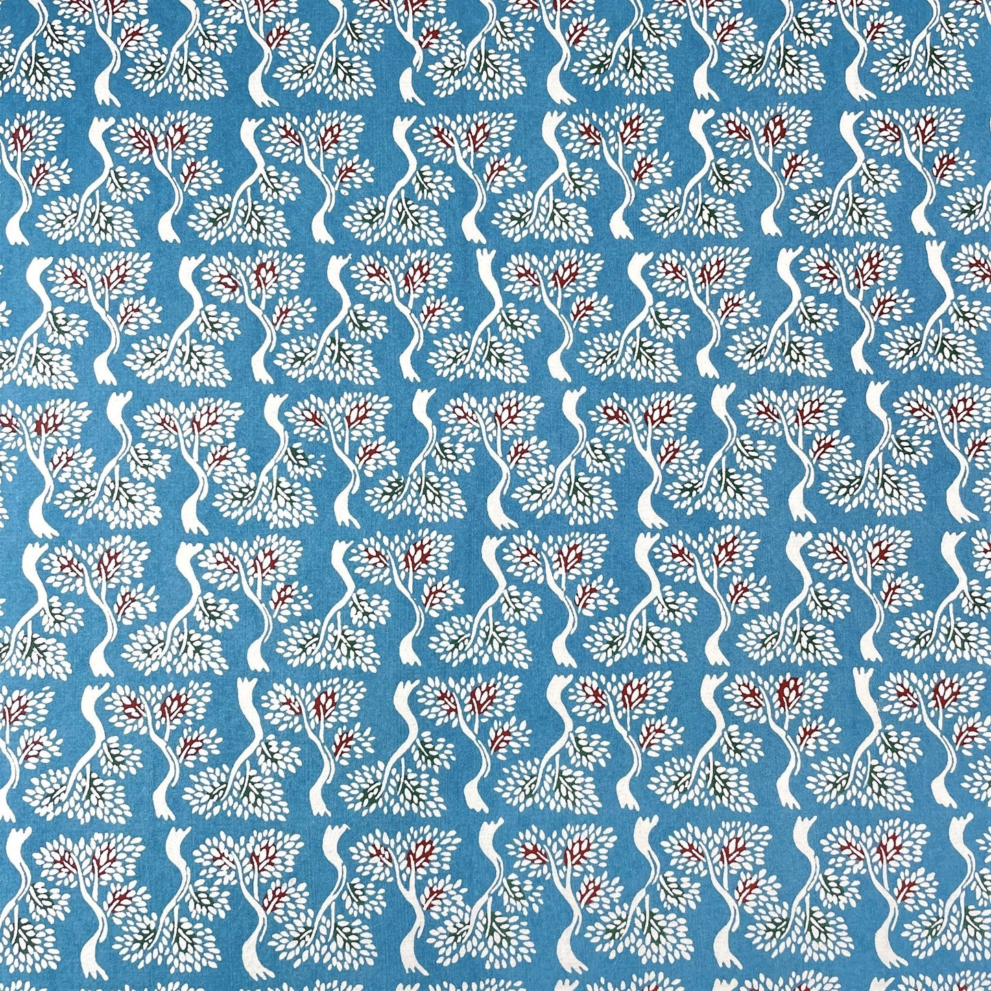 japanese stencil-dyed handmade paper with bonsai tree repeat pattern on blue backdrop