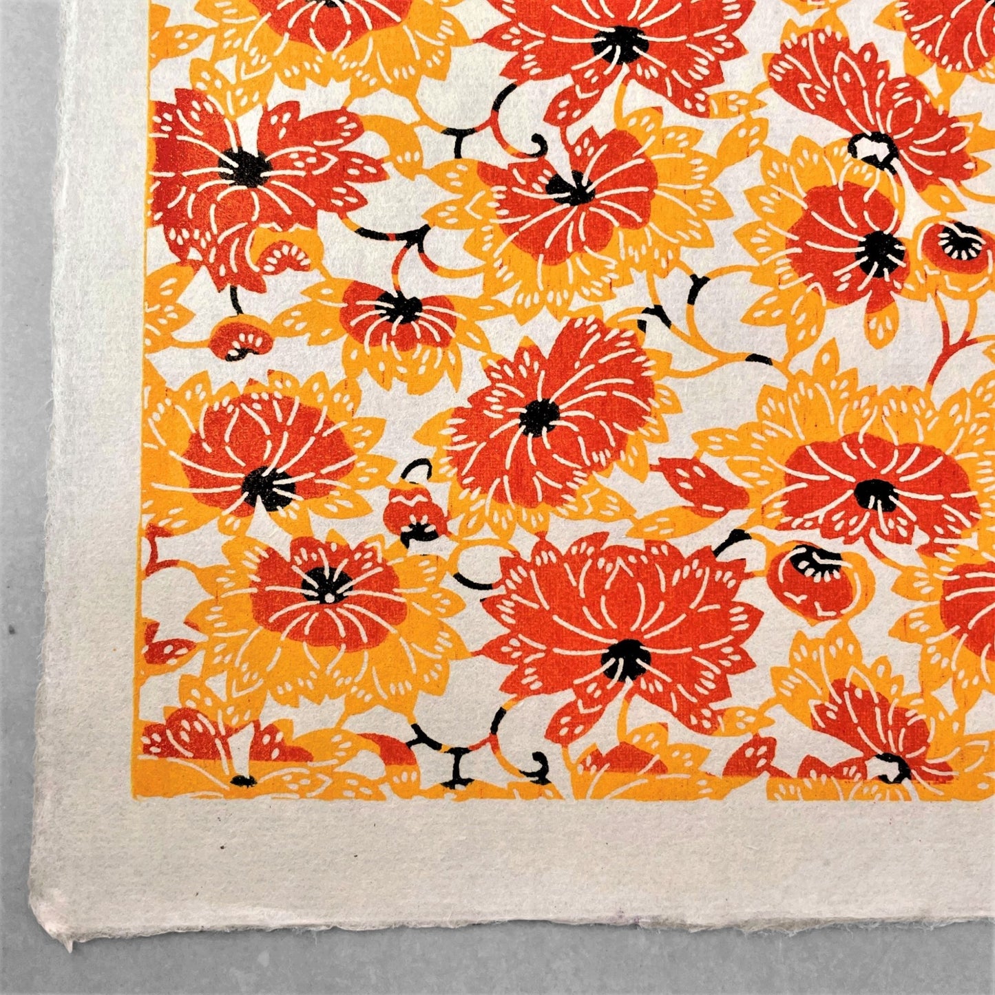 japanese stencil-dyed handmade paper with yellow and orange chrysanthemum repeat pattern