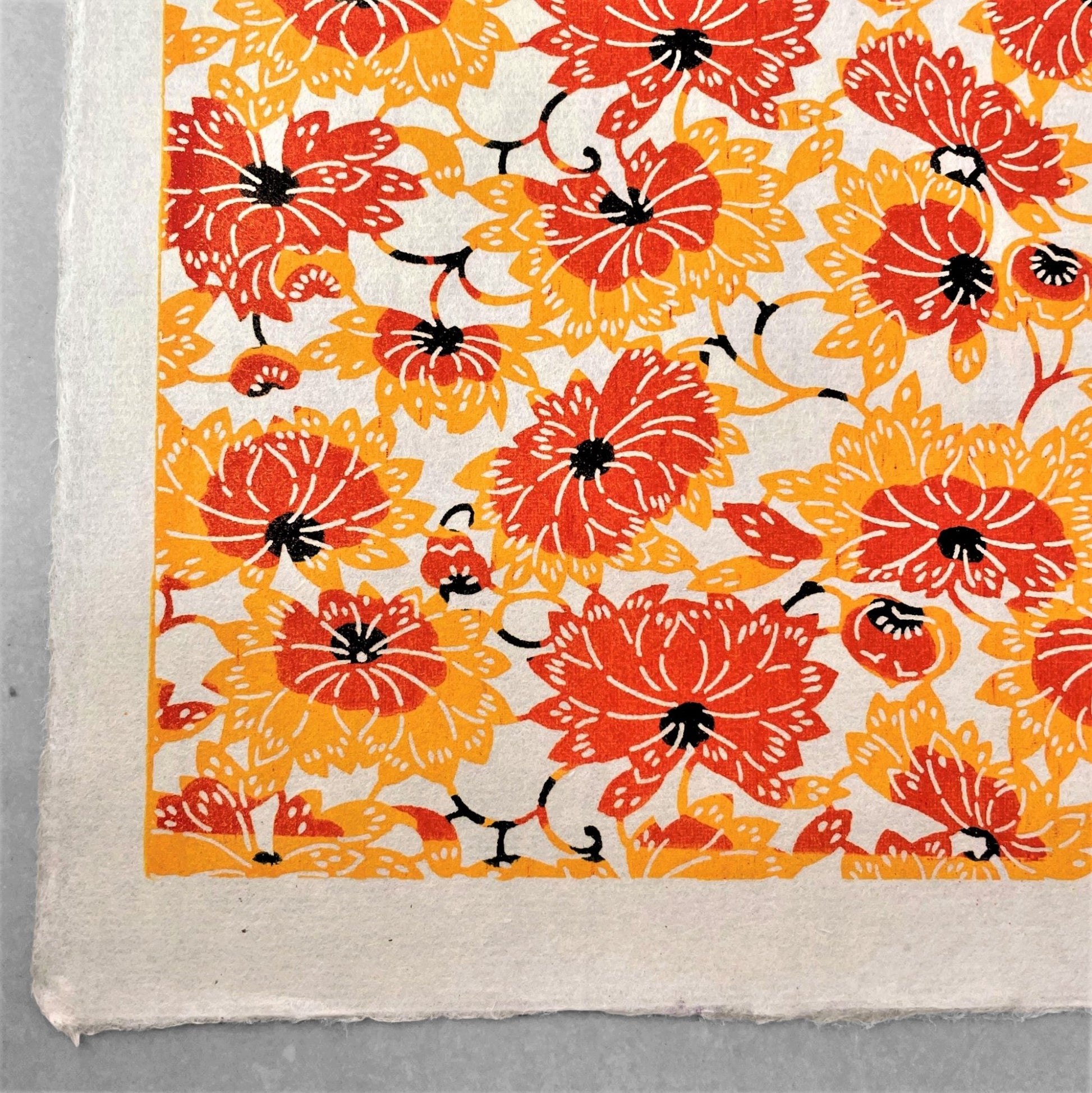japanese stencil-dyed handmade paper with yellow and orange chrysanthemum repeat pattern