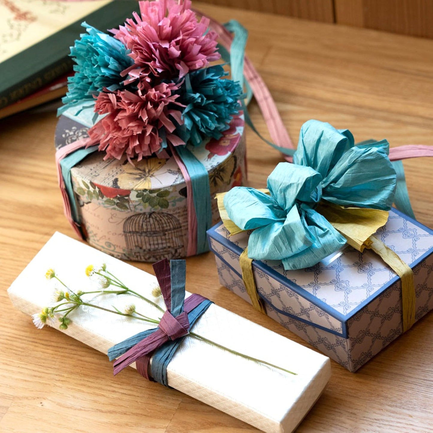 present wrapped with Japanese paper string as flat, bows and pom poms