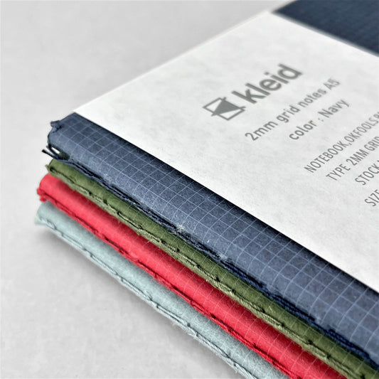 A5 soft cover notebook, cover is navy with a small white grid pattern by Japanese brand Kleid