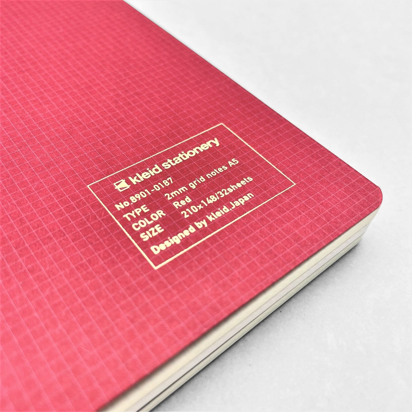 A5 soft cover notebook, cover is red with a small white grid pattern by Japanese brand Kleid
