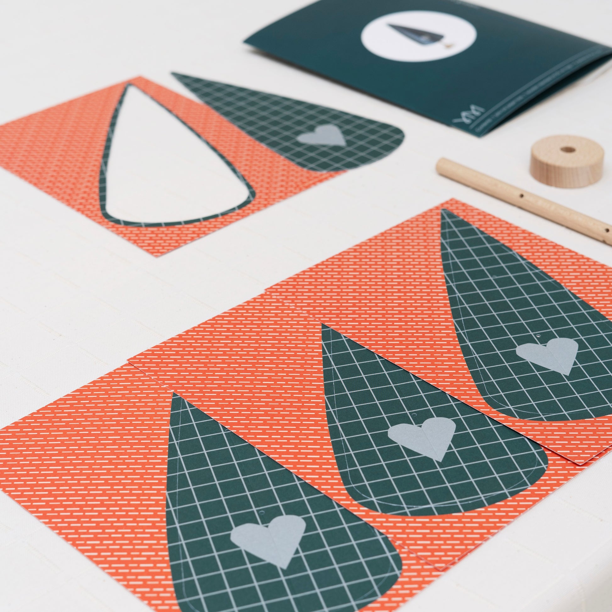 paper craft kit of a dark green cypress tree by Jurianne Matter, pictured the components ready to assemble