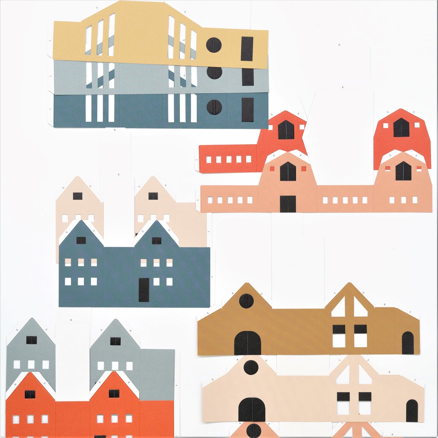 set of 12 colourful paper houses by Jurianne Matter, pictured ready to assemble