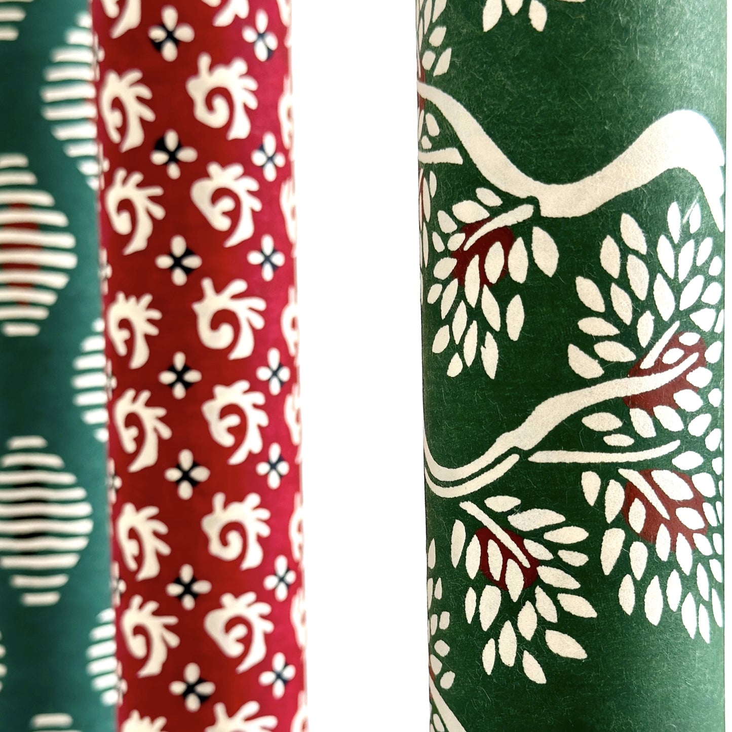 A Japanese stencil-dyed patterned paper in dark green with a repeat pattern of white bonsai trees. Close0up