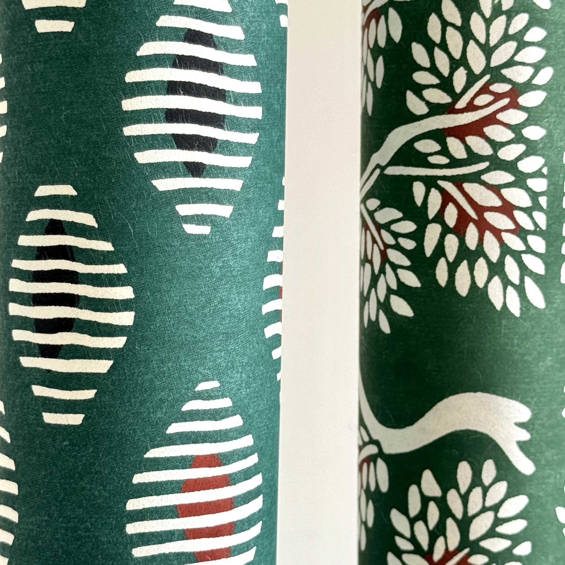 japanese stencil-dyed paper with geometric oval pattern in white, black and red on green background. Close-up