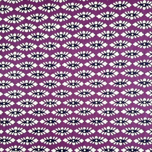 japanese katazome-shi paper (stencil-dyed) with a white and black repeat pattern on purple.