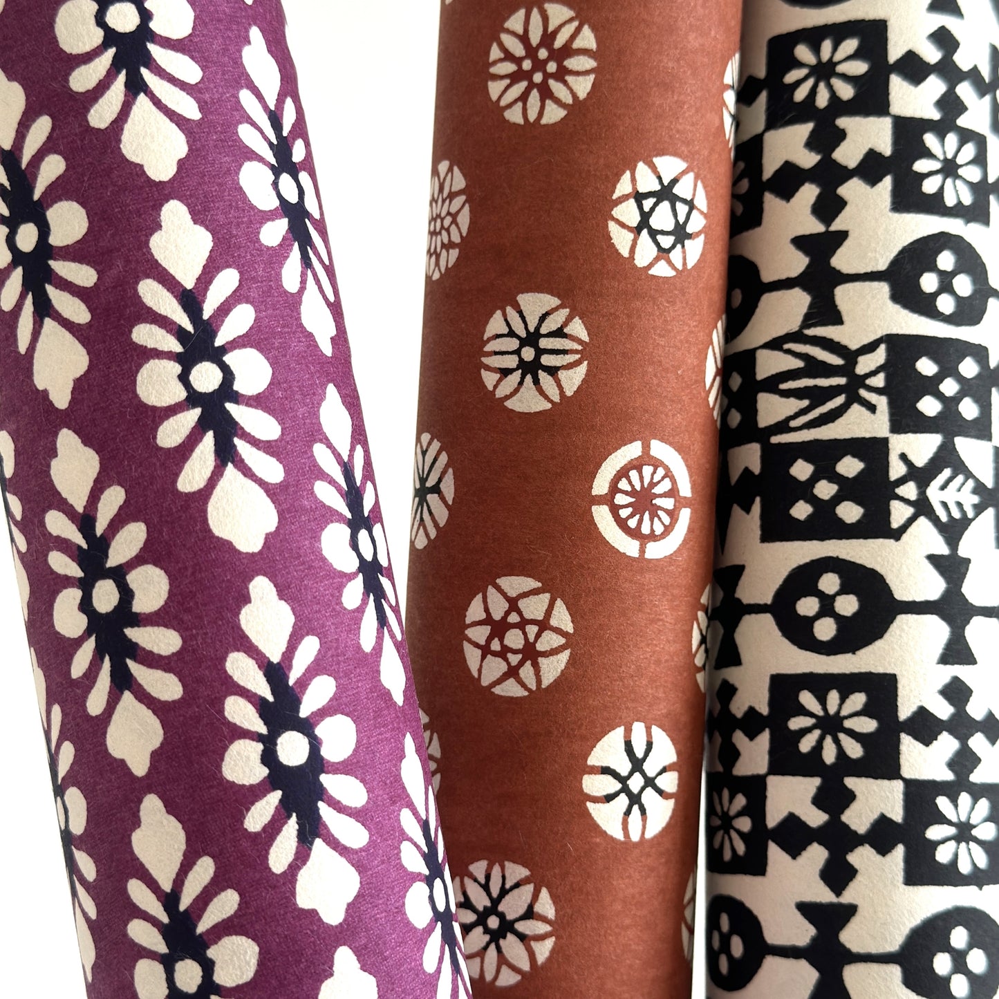 japanese katazome-shi paper (stencil-dyed) with a white and black repeat pattern on purple. Close-up