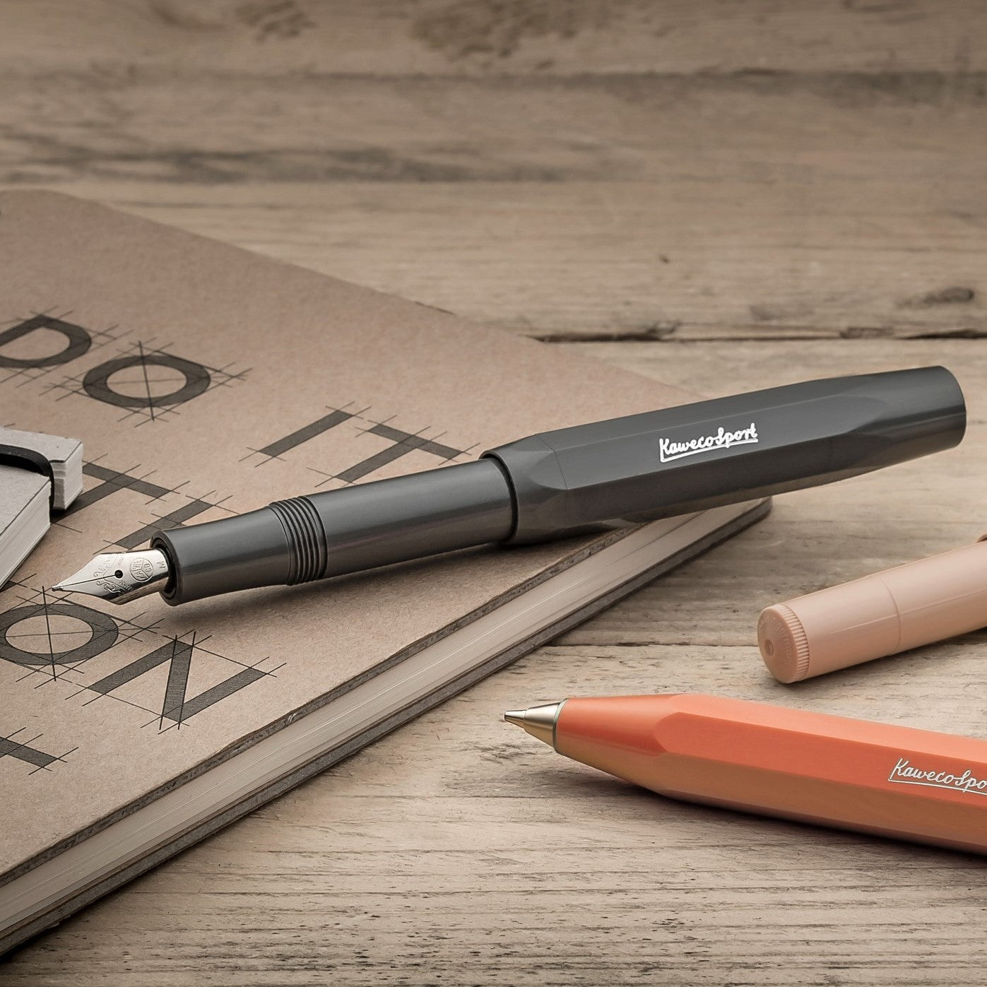 Kaweco Skyline Sport fountain pen in grey, pictured on a notebook