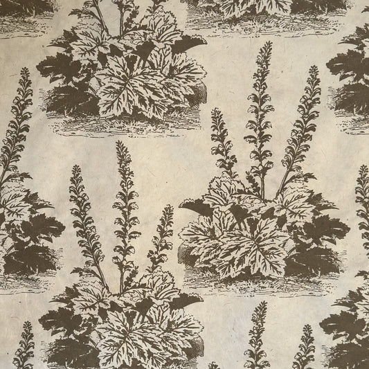 Nepalese handmade decorative lokta paper sheet with a Toile de Jouy style pattern of an agapanthus flower is dark moss screen printed on an ivory lokta paper.