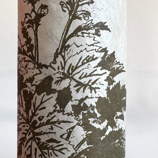 Nepalese handmade decorative lokta paper sheet with a Toile de Jouy style pattern of an agapanthus flower is dark moss screen printed on an ivory lokta paper. close up
