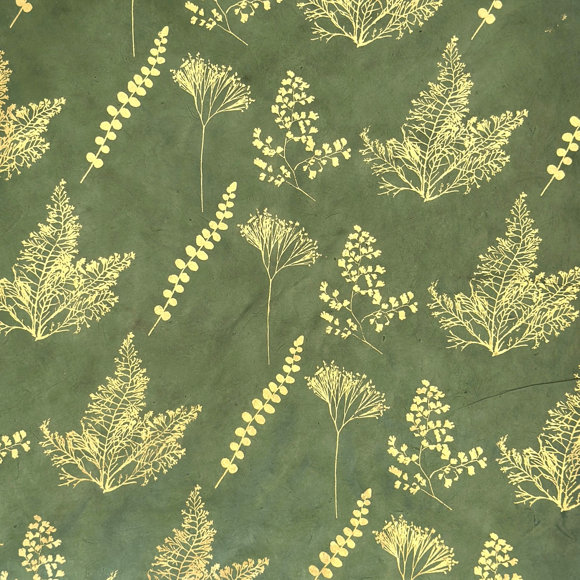 Nepalese handmade decorative lokta paper sheet with gold leaves screen printed on a green lokta paper