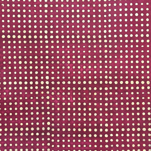 Nepalese handmade decorative lokta paper sheet with a pattern of white dots on burgundy red lokta paper.  Batik dyed using carved wooden blocks.