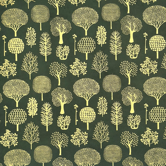 Nepalese handmade decorative lokta paper sheet with gold trees screen printed on a dark green lokta paper.