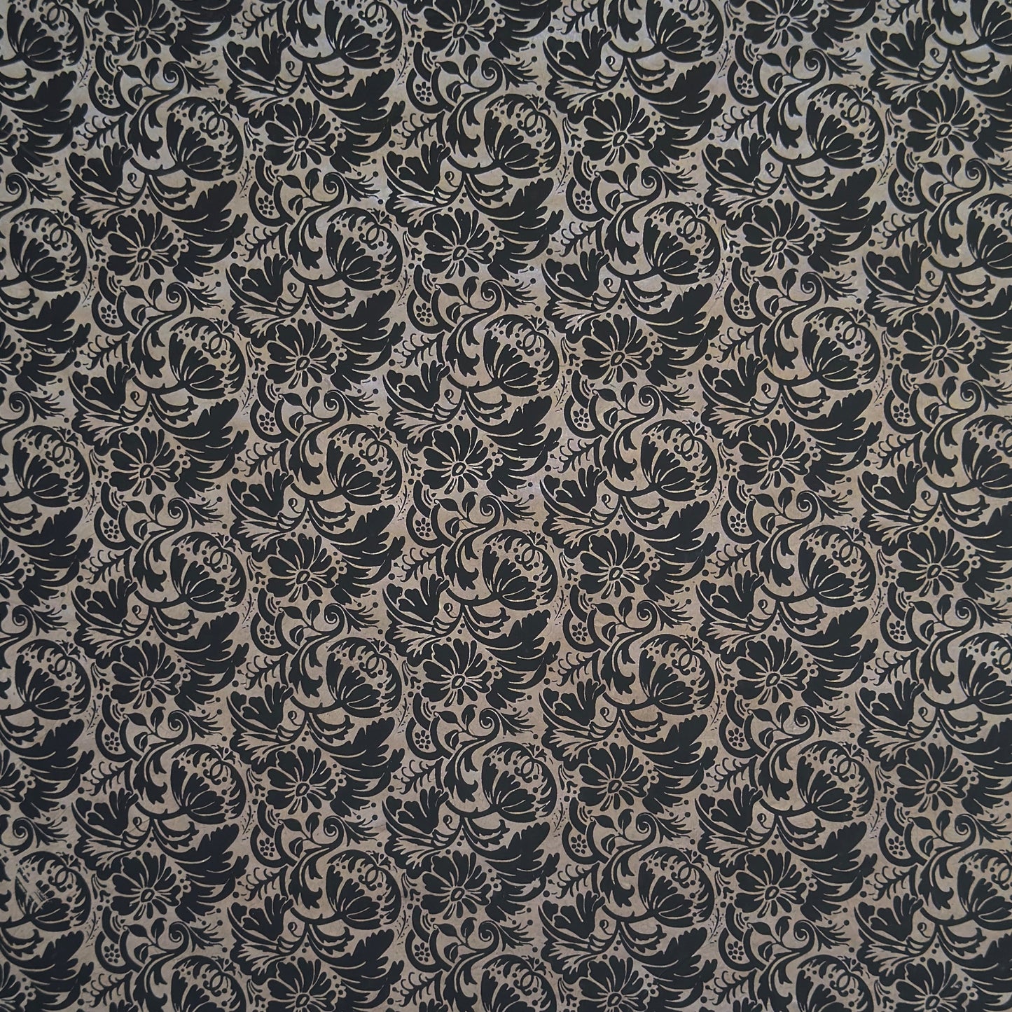 Nepalese handmade decorative lokta paper sheet with a black floral pattern screen printed on a dark taupe lokta paper.