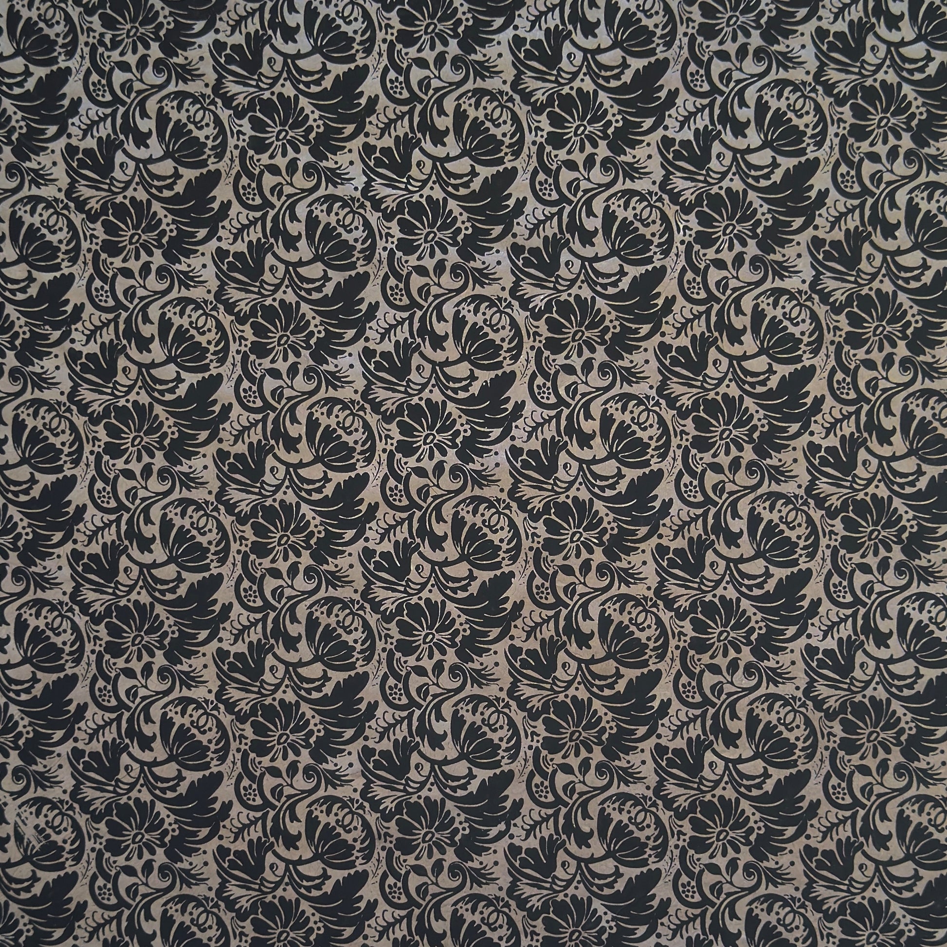 Nepalese handmade decorative lokta paper sheet with a black floral pattern screen printed on a dark taupe lokta paper.