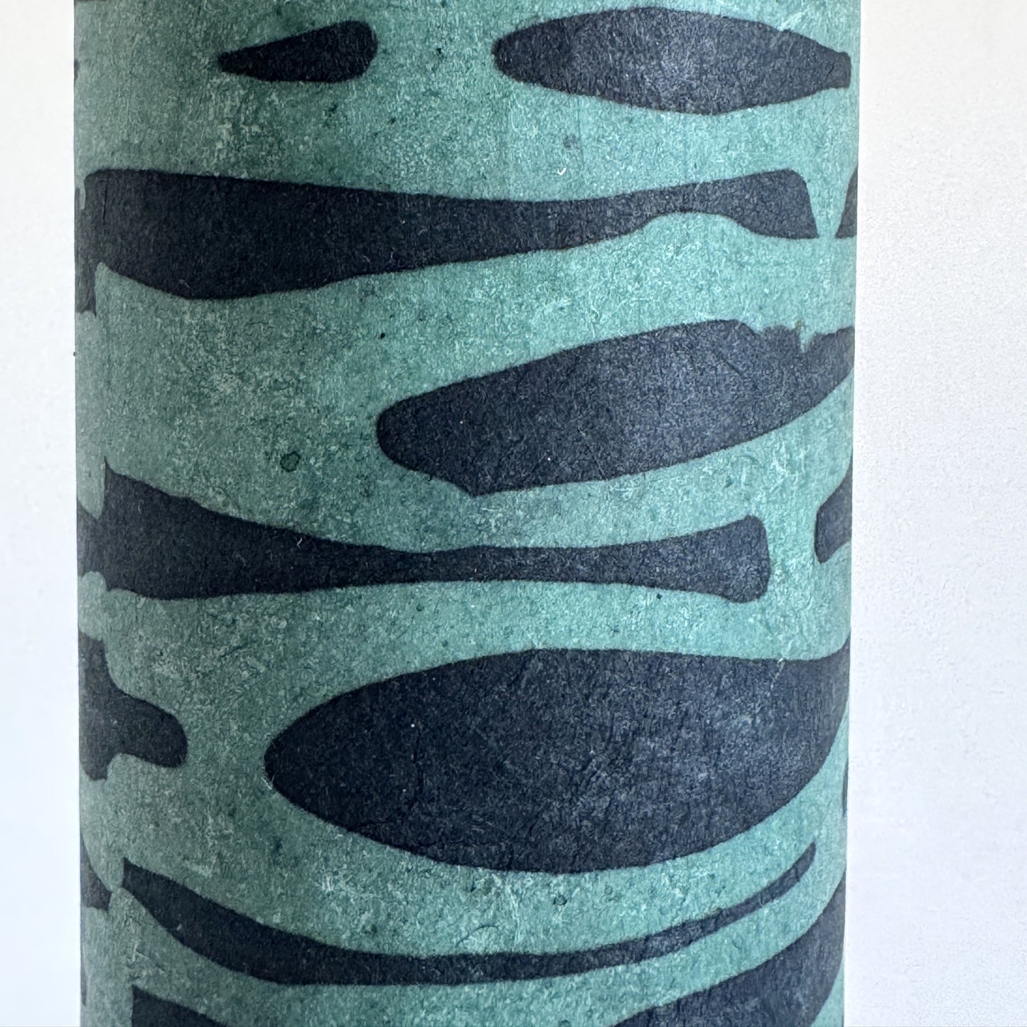 Nepalese handmade decorative lokta paper sheet with an abstract pattern in aqua and teal.  Batik dyed using carved wooden blocks. Close up