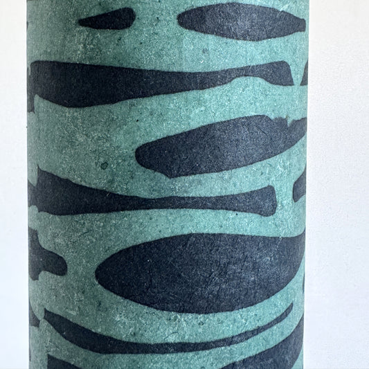 Nepalese handmade decorative lokta paper sheet with an abstract pattern in aqua and teal.  Batik dyed using carved wooden blocks. Close up