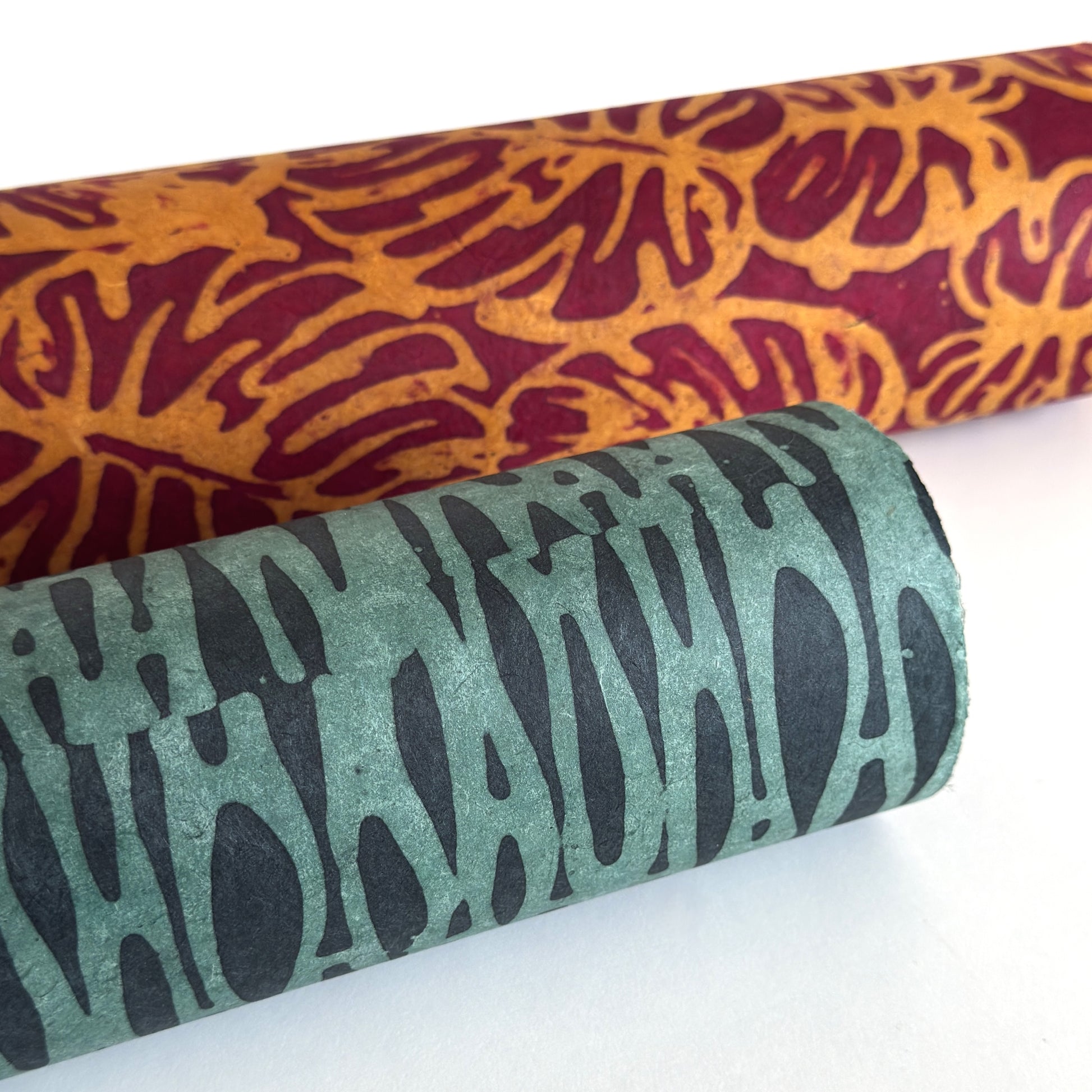 Nepalese handmade decorative lokta paper sheet with an abstract pattern in aqua and teal.  Batik dyed using carved wooden blocks. Rolled