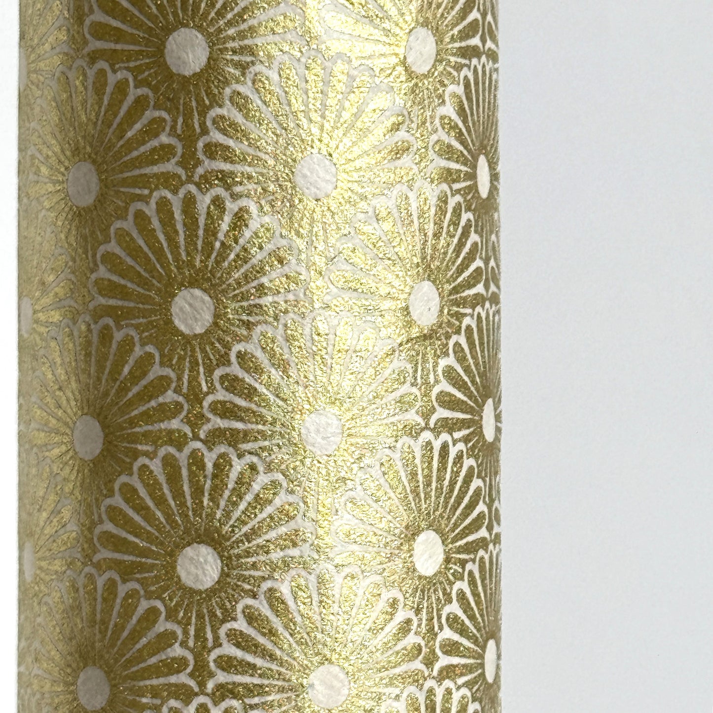 Nepalese handmade decorative lokta paper sheet with a gold metallic repeat floral pattern screen printed on an ivory lokta paper. Close up