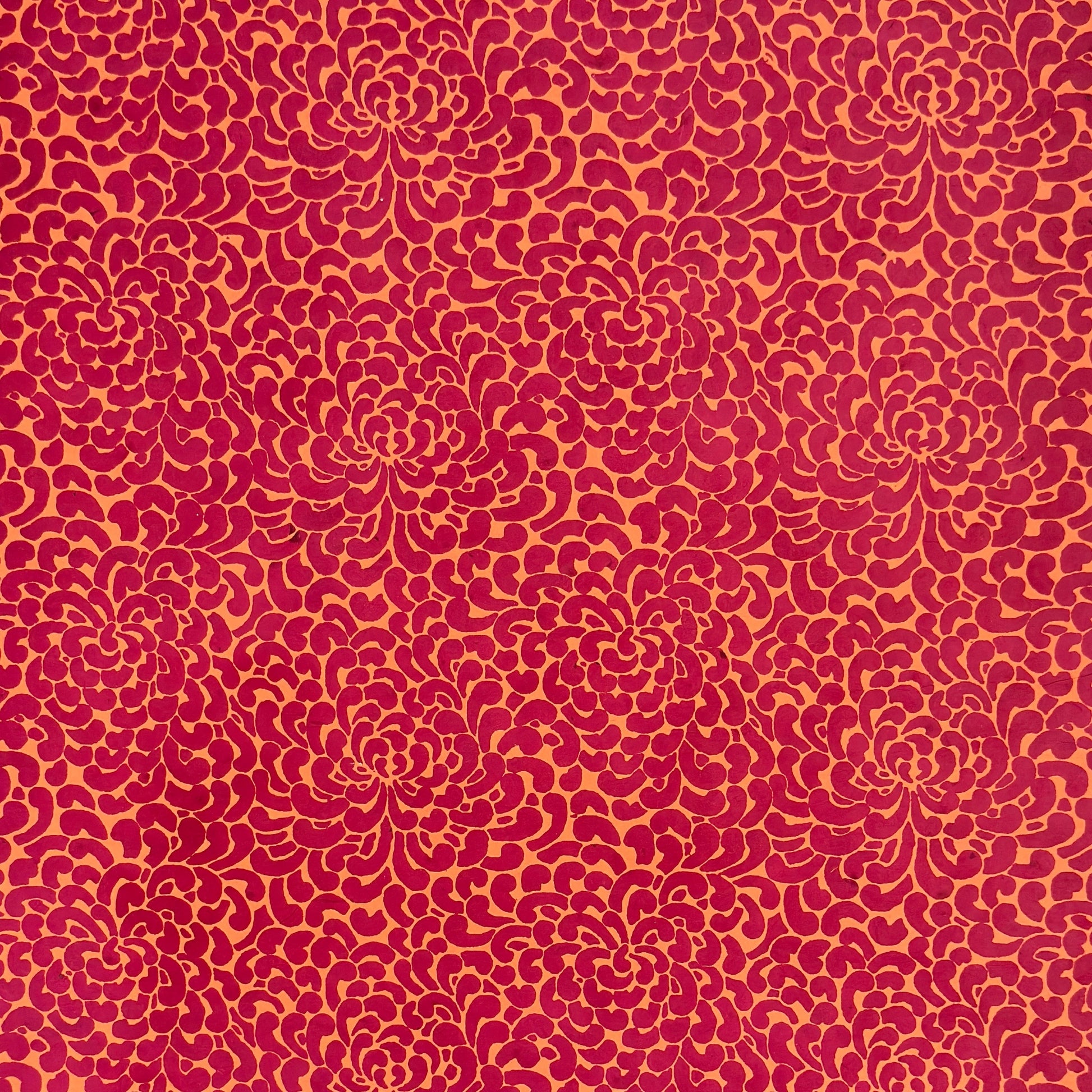 Nepalese handmade lokta paper sheet with a screen printed coral floral design on fuchsia lokta paper