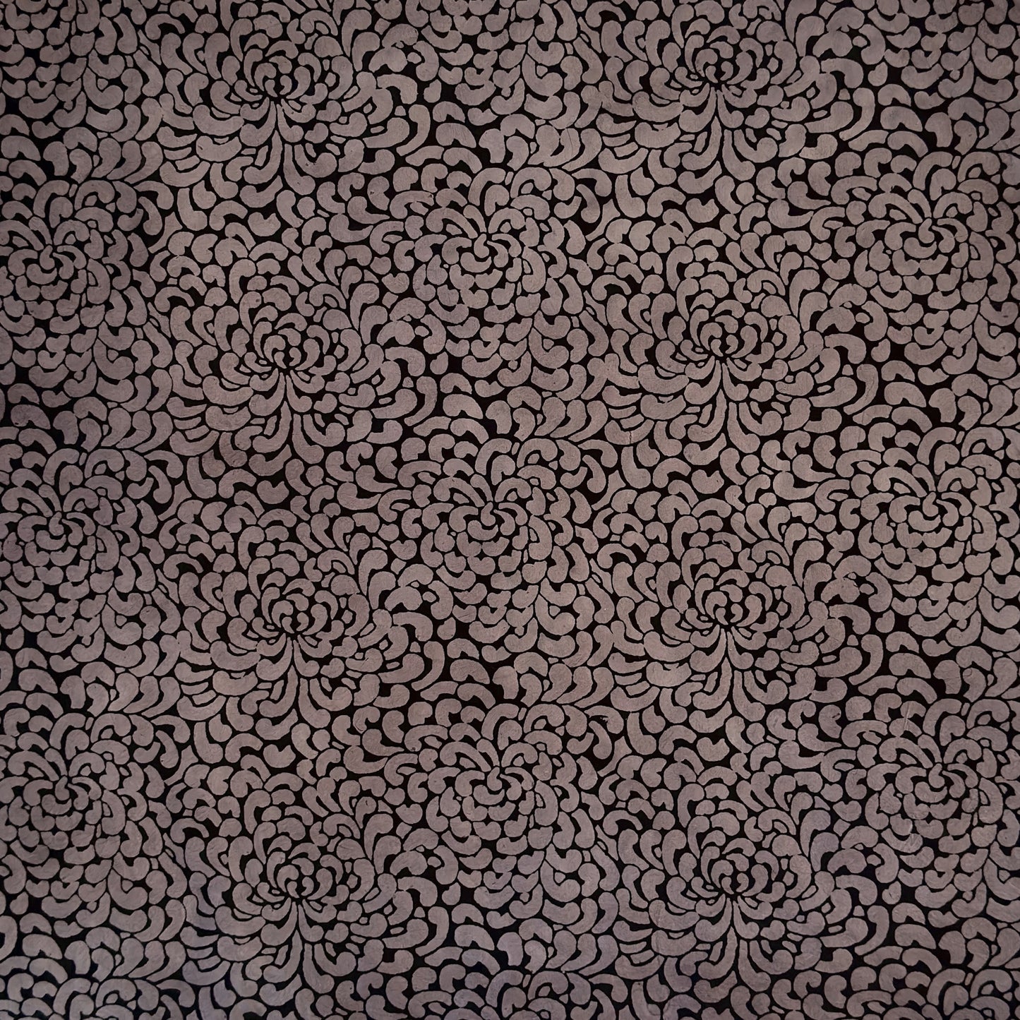 Nepalese handmade lokta paper sheet with a screen printed black floral design on slate lokta paper