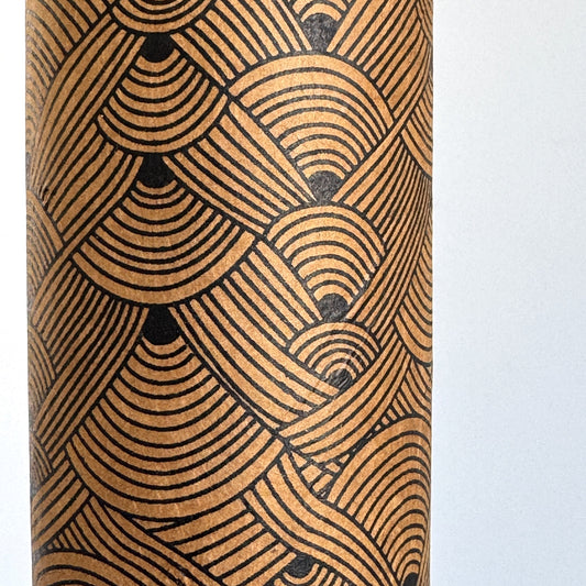 Nepalese handmade decorative lokta paper sheet with a fine lined black knots pattern screen printed on a brown lokta paper. Close up