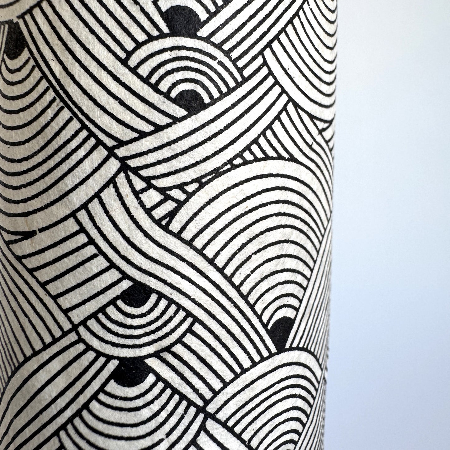 Nepalese handmade decorative lokta paper sheet with a fine lined black knots pattern screen printed on an ivory lokta paper. Close up