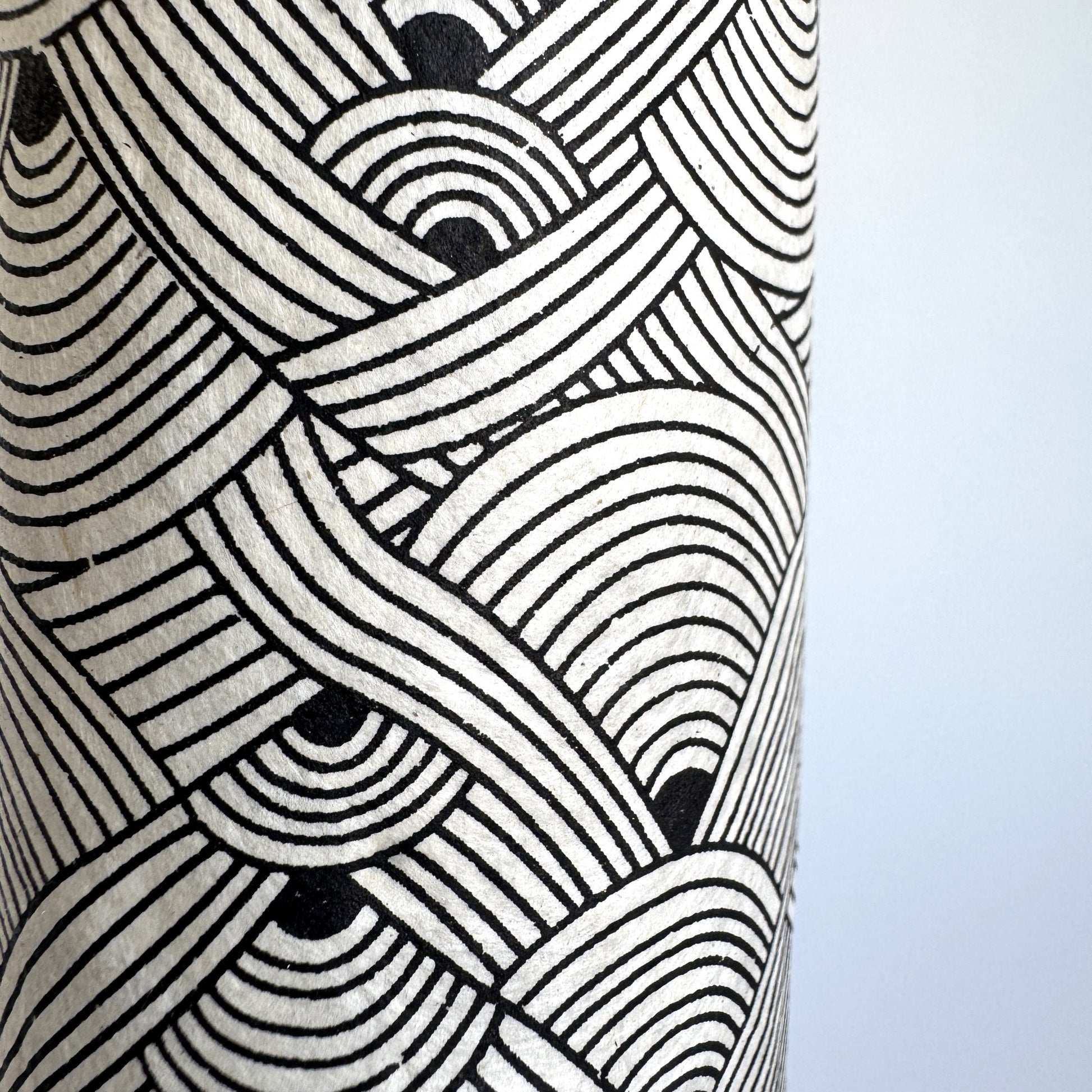 Nepalese handmade decorative lokta paper sheet with a fine lined black knots pattern screen printed on an ivory lokta paper. Close up