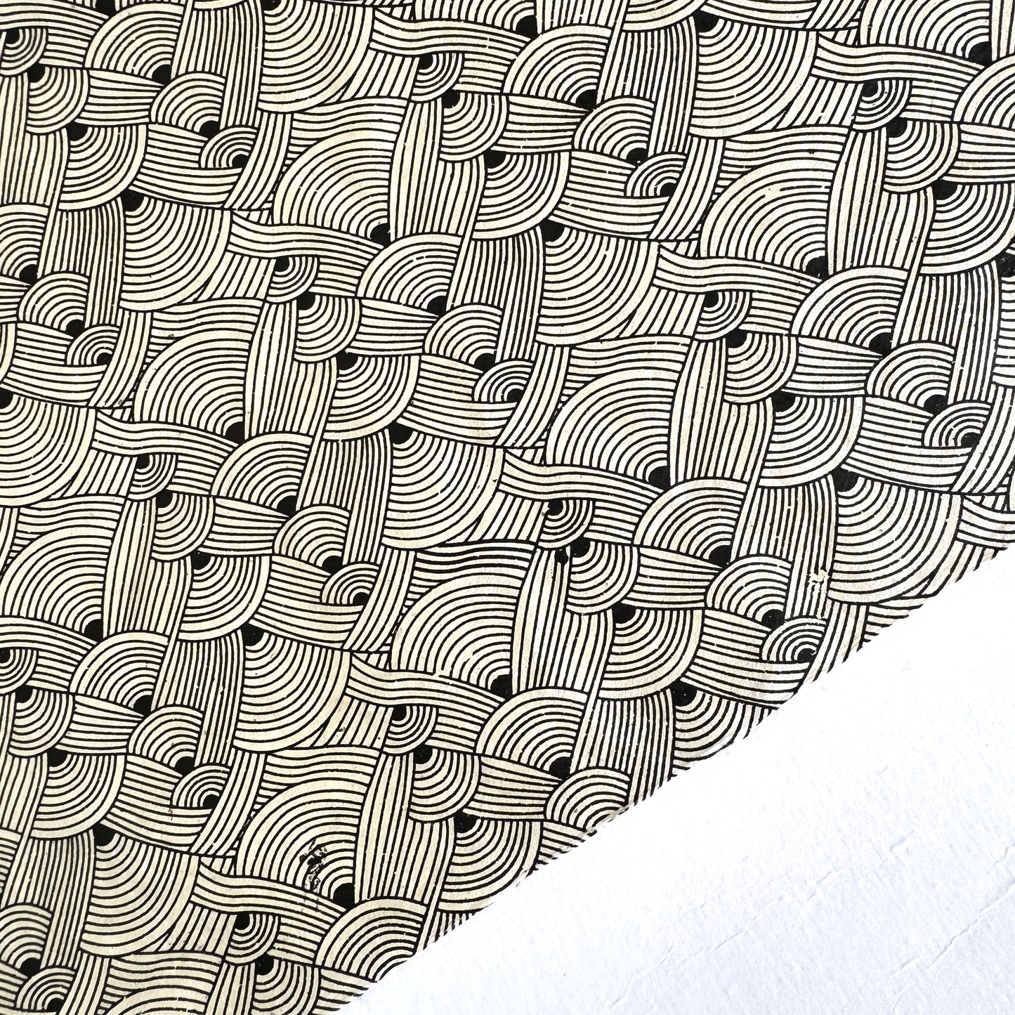 Nepalese handmade decorative lokta paper sheet with a fine lined black knots pattern screen printed on an ivory lokta paper.