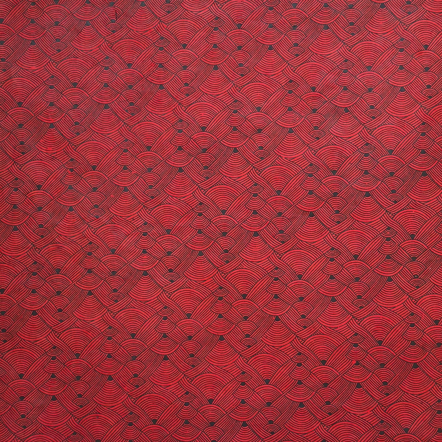 Nepalese handmade decorative lokta paper sheet with a fine lined black knots pattern screen printed on a red lokta paper.