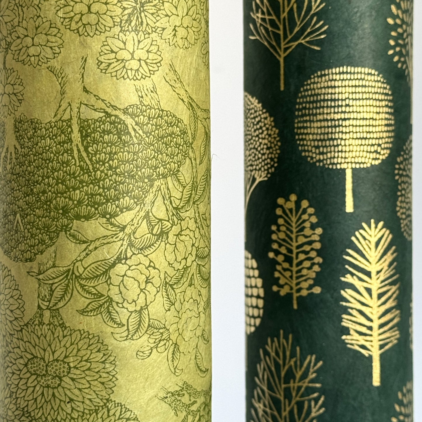Nepalese handmade decorative lokta paper sheet with a detailed design of trees and flowers in dark green screen printed on a green lokta paper. Close up