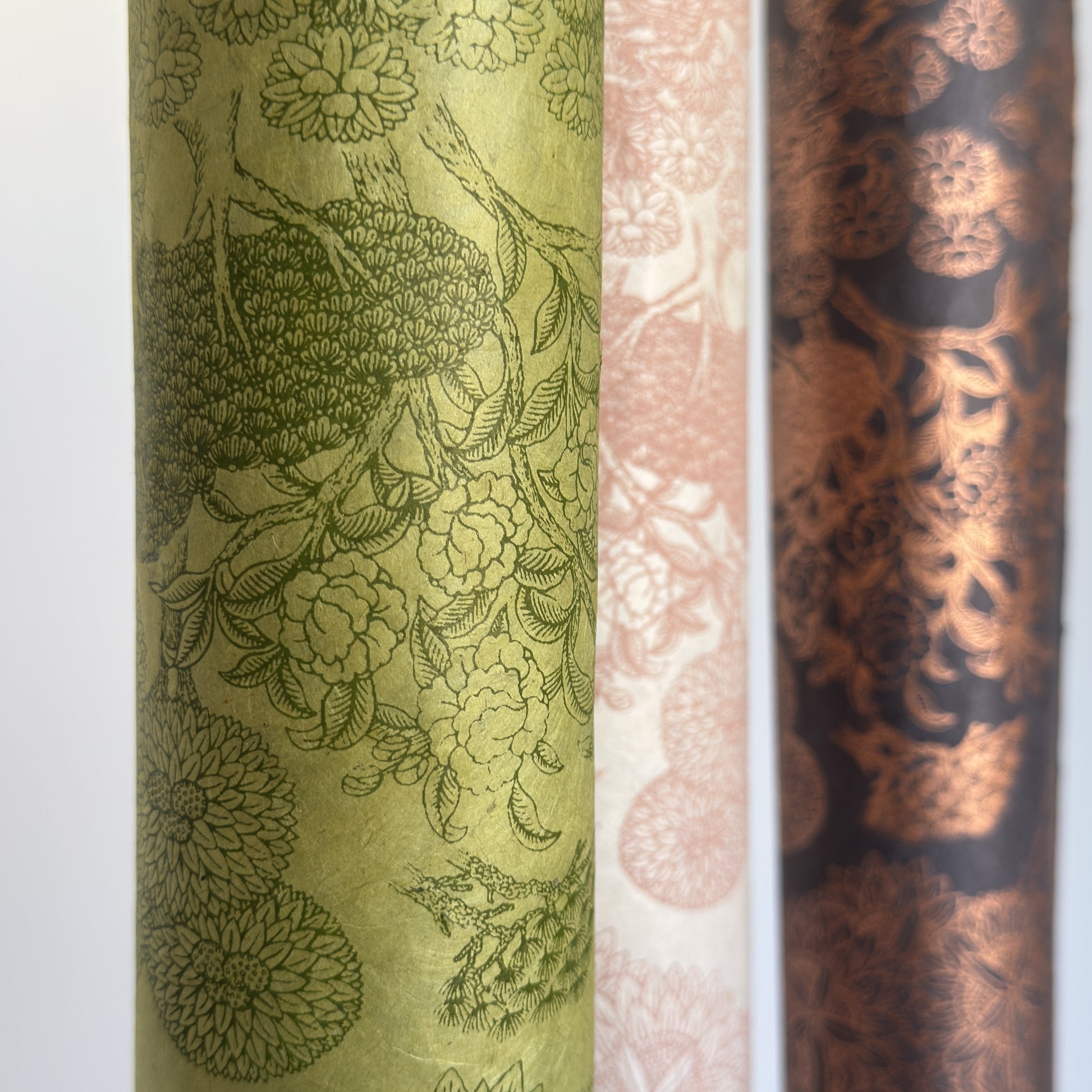 Nepalese handmade decorative lokta paper sheet with a detailed design of trees and flowers in dark green screen printed on a green lokta paper.