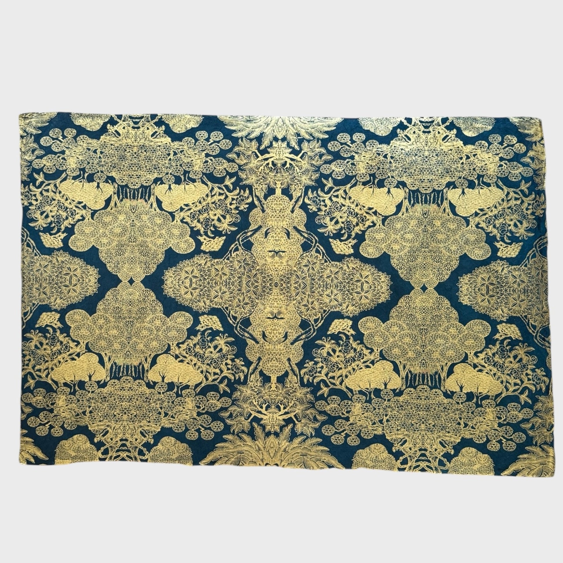 Nepalese handmade decorative lokta paper sheet with a detailed design of trees and flowers in gold metallic screen printed on a midnight blue lokta paper. Full sheet of paper pictured flat