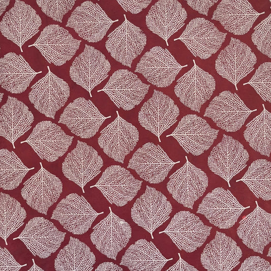 Nepalese handmade decorative lokta paper sheet with a white leaf pattern screen printed on a burgundy lokta paper.