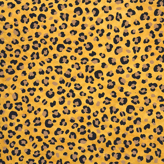Nepalese handmade decorative lokta paper sheet with an animal print design in two colours, tan and black, screen printed on a yellow lokta paper.