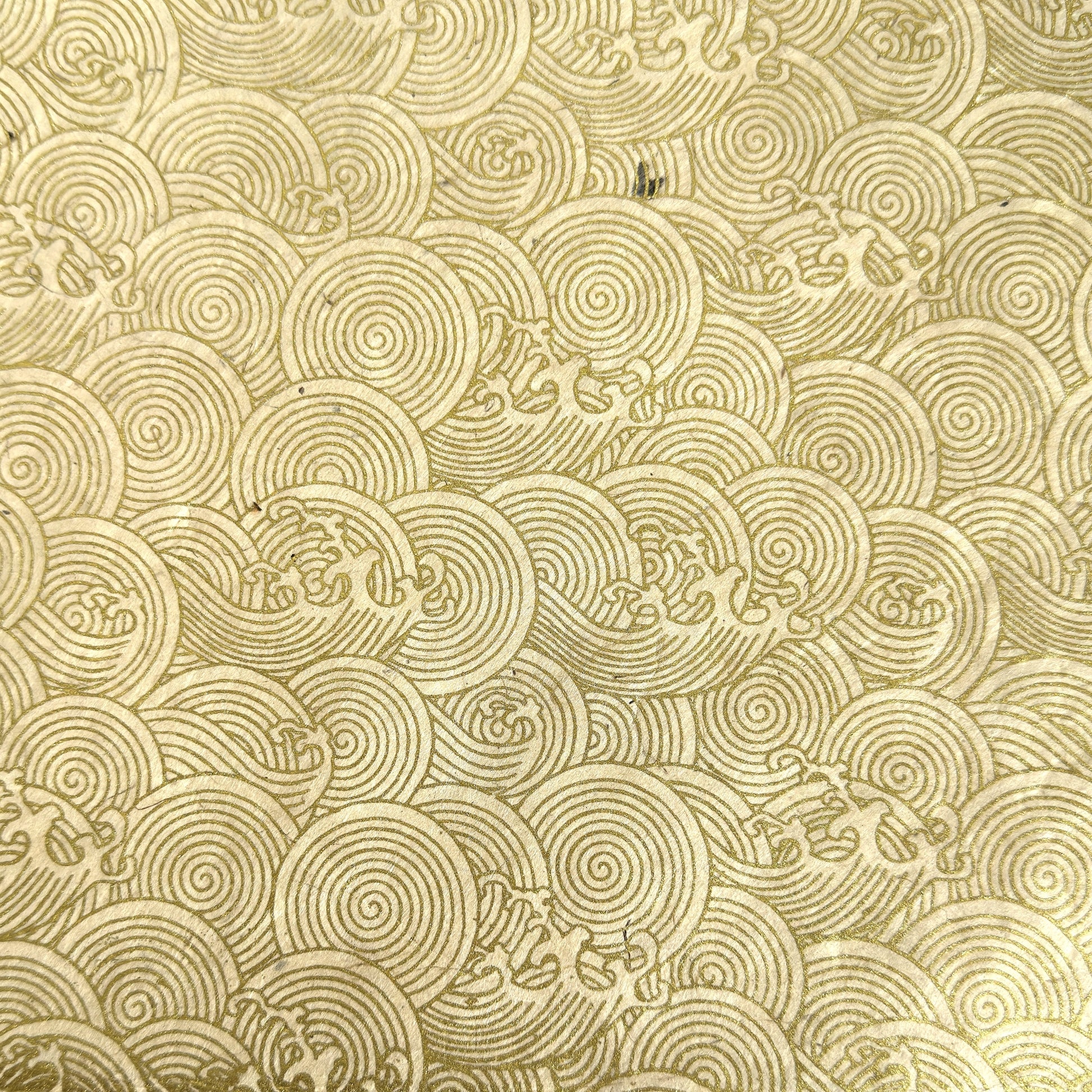 Nepalese handmade decorative lokta paper sheet with a metallic gold wave design screen printed on an ivory lokta paper.
